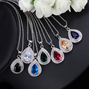 Macro shot of 7 multicolored pear-shaped zircon necklaces on black display stand