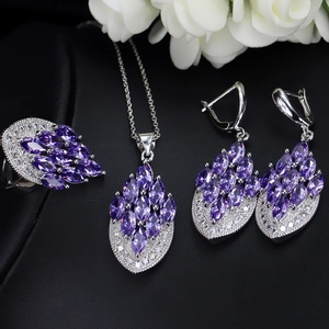Detailed view of bridal jewelry set with purple marquise zircon and silver leaf patterns