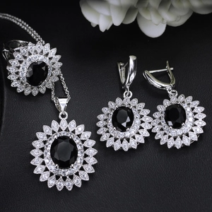 Detailed set of sunflower jewelry with black oval stones and white cubic zirconia