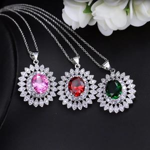 Detail of sunburst necklaces with oval pink, red, and green cubic zirconia pendants