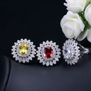 Detailed view of sunflower rings with yellow, red, and white oval zircon gemstones
