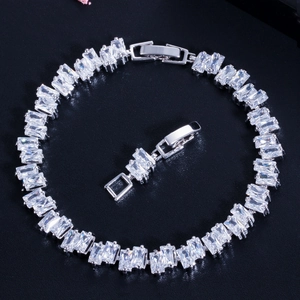Classic silver tennis bracelet featuring baguette-cut AAA cubic zirconia on black background