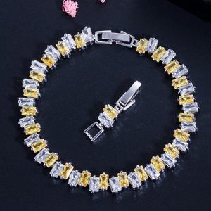 Detail of silver bracelet with yellow and white rectangular zirconia and folding clasp