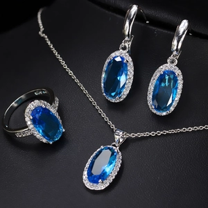 Detail of luxury bridal jewelry set with oval blue zircon necklace and earrings