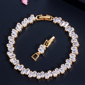 Detailed macro view of gold-plated bracelet with rectangular AAA cubic zirconia and extension clasp