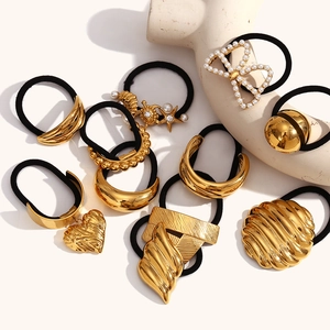 Close-up of gold 18K plated stainless steel hair ties featuring ocean shells and pearls