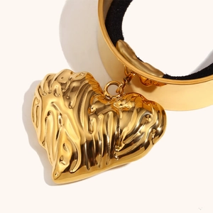 Minimalist 18K gold plated heart hair tie with pleated texture on white background