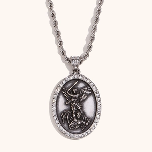 Macro shot of 18K gold Angel St. Michael pendant with rhinestones and twisted rope chain