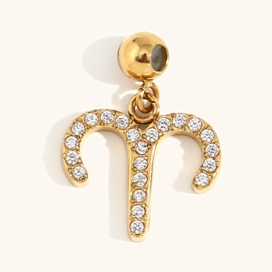 Macro shot of 18K gold plated Aries zodiac pendant encrusted with white cubic zirconia