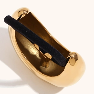 Polished 18K gold-plated moon-shaped metal hair tie with elastic rope on beige background