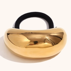 Macro detail of the 18K gold-plated crescent metal ornament with mirror finish