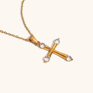 Detailed close-up of 18K gold-plated cross pendant necklace with sparkling zircon stones