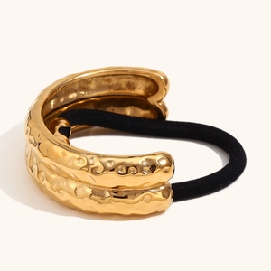 Detail of 18K gold plated hair tie with hammered texture and elastic cord