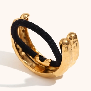 Detail of 18K gold plated hair cuff featuring a luxury hammered texture and elastic band