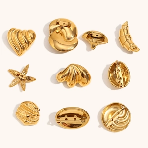 Golden stainless steel heart and teardrop brooches with textured metallic finish