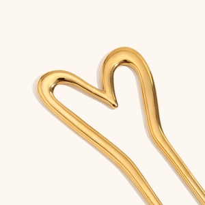 Detailed macro shot of a heart-shaped gold-plated stainless steel hair pin ornament