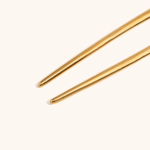 Macro shot of 18K gold plated stainless steel hair pin tips with polished mirror finish