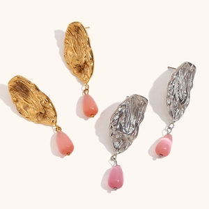 Vintage 18K gold butterfly wing earrings with pink teardrop stone on white background