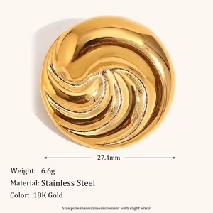 Macro detail of gold plated stainless steel swirl brooch with size and weight info