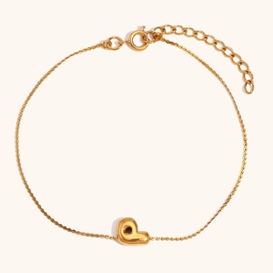 Macro shot of 18K gold-plated bubble letter P pendant on a polished link chain bracelet
