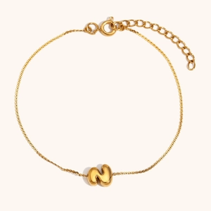 Macro view of 18K gold plated chain with bubble letter N pendant and adjustable clasp