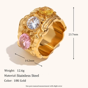 Macro view of chunky 18K gold plated stainless steel ring with three colorful gemstones