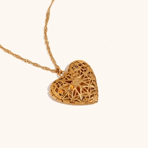 Detailed view of hollow heart locket necklace in 18K gold plated stainless steel finish