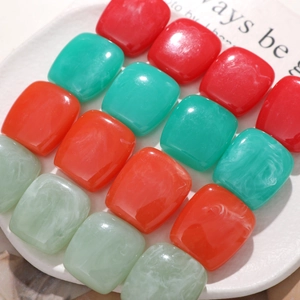 Detail of square resin beads with marble texture for DIY jewelry and earring making