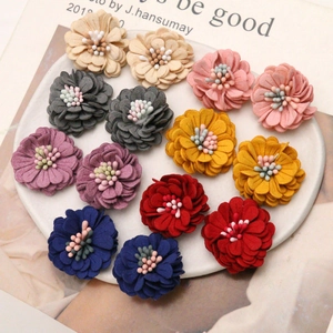Macro shot of 3cm microfiber daisy flowers for DIY hair accessories in assorted colors