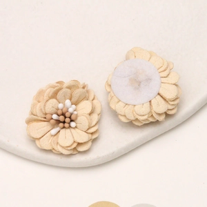 Detail of handmade cream microfiber daisy flowers with textured petals for DIY crafts