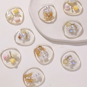 Handmade DIY hair clip charms with resin, pearls, gold butterflies, and shell pieces