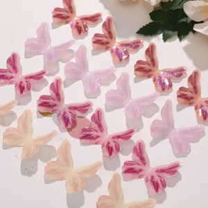 Close-up of colorful resin butterfly charms with glitter finish for DIY jewelry crafts