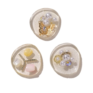 Three DIY resin charms with pearls, butterflies, and rhinestones for hairpins and shoes