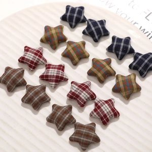Japanese retro plaid star-shaped fabric buttons arranged on a white ceramic plate