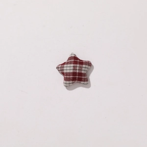 Detailed view of 3D padded star pendant in red and white plaid woven fabric