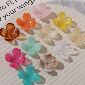 Macro shot of colorful acrylic four-petal flower charms for DIY jewelry making