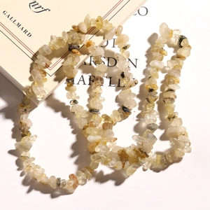 Close-up of irregular natural rutilated quartz stone beads for DIY jewelry making