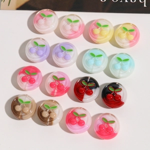 Mix of colorful cherry resin beads for DIY jewelry making on white background