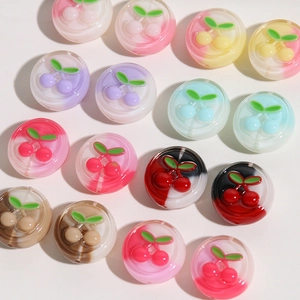 Detailed close-up of translucent round resin beads with 3D cherry motifs for DIY crafts