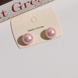 Close-up of 12mm pink iridescent gradient mermaid faux pearl stud earrings on display card