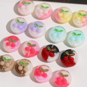 Close-up of translucent resin cherry charms with embedded leaves for DIY jewelry making