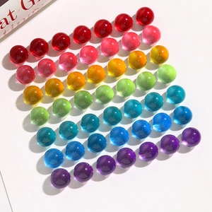 Macro shot of 14mm colorful transparent round resin beads in a rainbow gradient arrangement