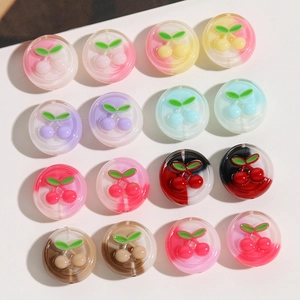 Close-up of cute translucent resin cherry beads with 3D relief for DIY jewelry making
