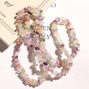 Macro detail of irregular multi-colored natural fluorite crystal stone beads on a book