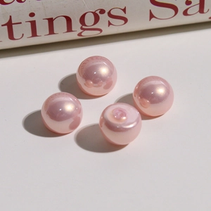 Macro shot of 12mm iridescent pink gradient faux pearls for DIY earring jewelry making