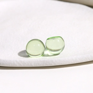 Detail view of 14mm light green translucent resin round dome cabochon for DIY crafts