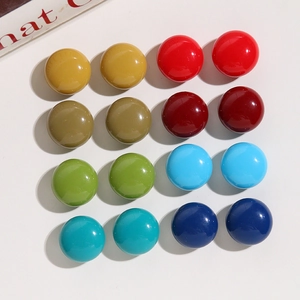 Flat lay of 16 colorful 18mm glossy resin cabochons arranged in pairs on white background