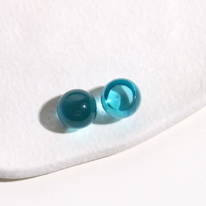 Macro detail of 14mm translucent blue jelly resin round cabochons for DIY jewelry making