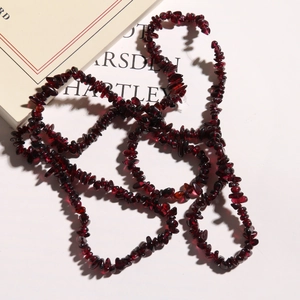 Detailed macro view of dark red irregular garnet stone beads for DIY jewelry making