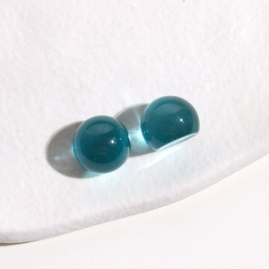 Detailed macro shot of 14mm clear teal resin beads for DIY jewelry and accessories